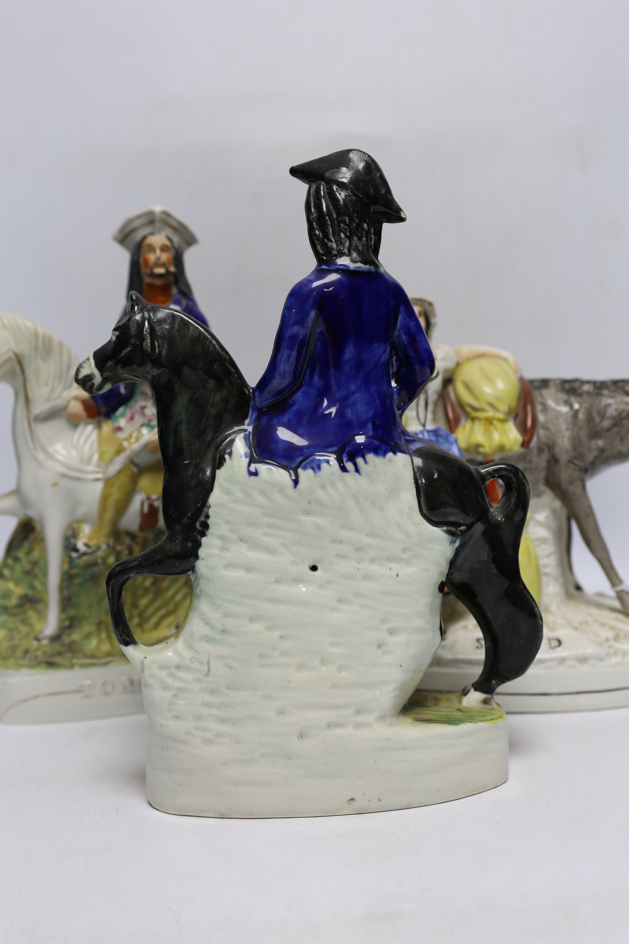 Three mid 19th century Staffordshire figure groups including Dick Turpin, Tom King and Sand, tallest 30cm